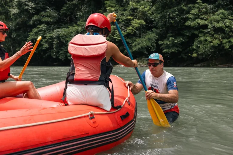 Personas haciendo rafting en río cerca de Turrialba, Costa Rica, rodeadas de naturaleza.